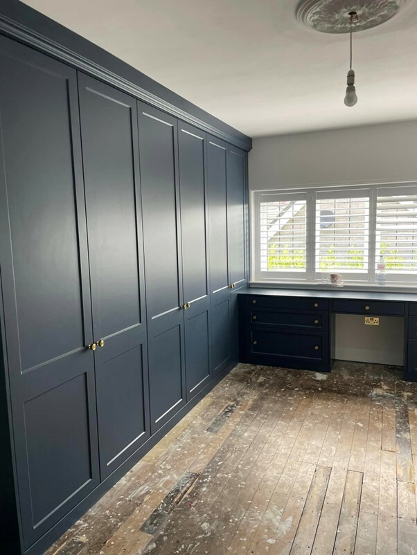 Wall-to-wall fitted wardrobes in Dorset in navy blue with hinged doors