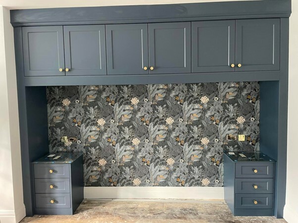 Bespoke bedroom furniture overbed storage and bedside tables in deep navy with gold handles