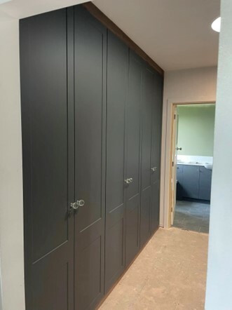 espoke fitted wardrobes with hinged doors.
