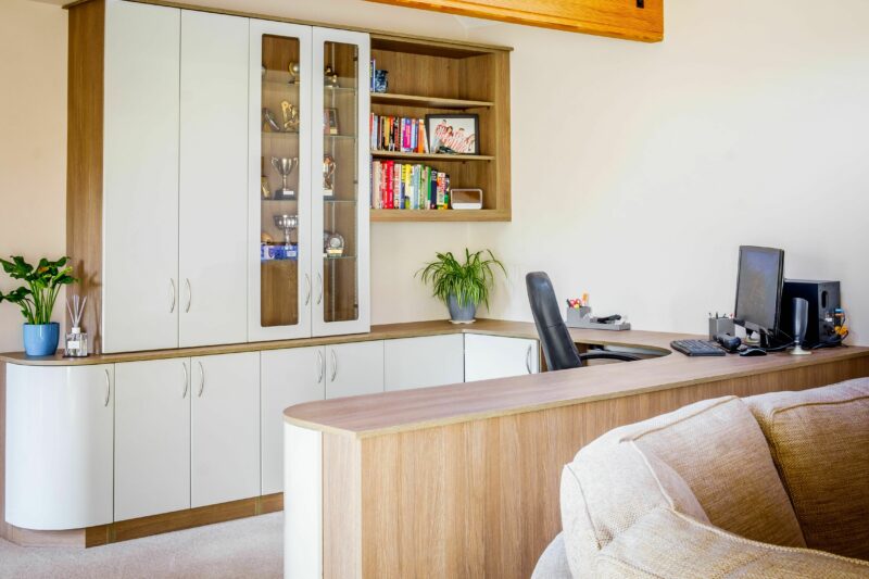 Large home office with bespoke home office furniture including shelves, cupboard storage and desk