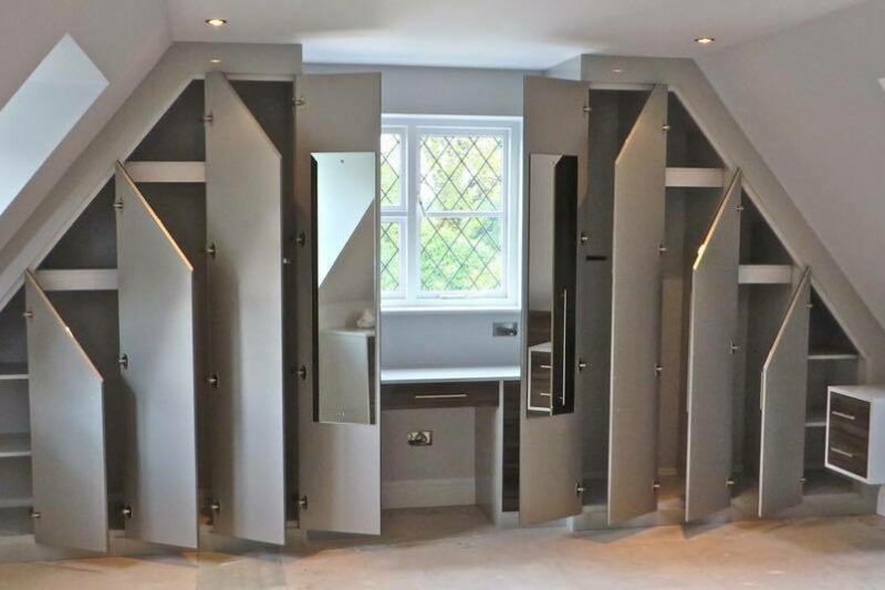Grey angled wardrobe in room with sloping ceilings, as well as loft fitted furniture des and shelving